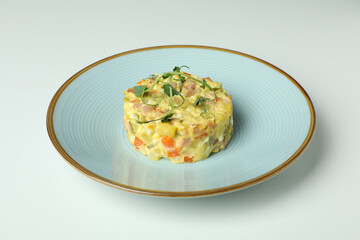 Plate with Olivier salad on white background