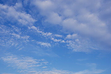 Naklejka na ściany i meble Whispers of the Sky: Floating Clouds on a Blue Canvas