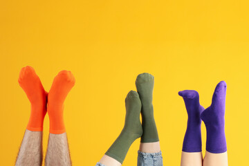 Legs in different socks on yellow background