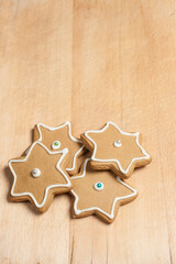 Star gingerbread cookies with frosting on wood board