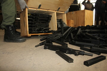 a pile of firearms ready to be destroyed - obrazy, fototapety, plakaty