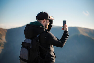 Tourist takes on smartphone mountain scenery