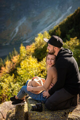 Fototapeta premium Young tourist couple, man and woman, on hiking path in mountains