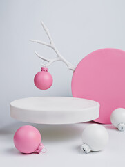 Creative Christmas layout made of podium, antlers and baubles on white background. Minimal Xmas or New year advertisement concept. Mock up showcase for product, promotion, sale or presentation.