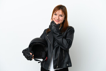 Redhead girl with a motorcycle helmet isolated on white background happy and smiling