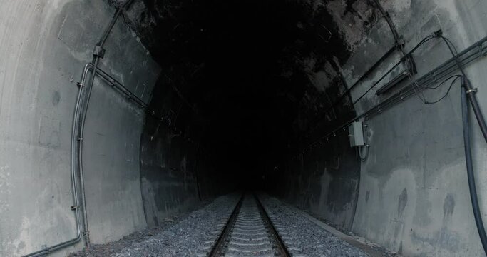 Railway line inside a dark tunnel at the end, No light at the end of tunnel. The symbol of hopeless.