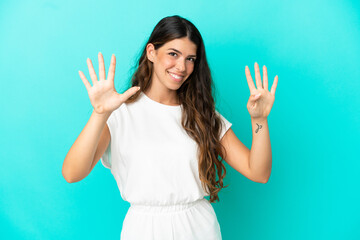 Young caucasian woman isolated on blue background counting nine with fingers