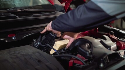 Replacing the car's air filter with a new one, maintenance, close-up