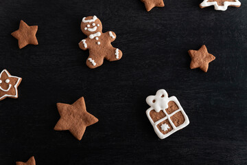 Gift box and stars from gingerbread on black background. Traditional pastries