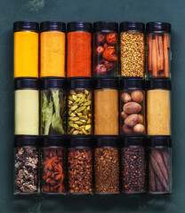 Spices and spicy banner. Colorful various spices, seasoning in glass jars, copy space, top view.