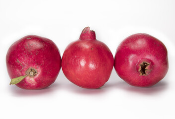 group of three pomegranate on white background