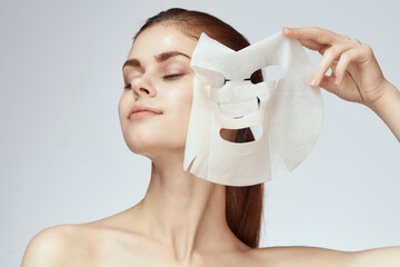 woman with bare shoulders and face mask skin care cosmetics