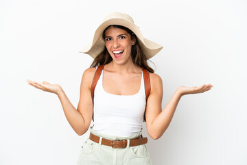 Young caucasian woman wearing a Pamela in summer holidays isolated on white background with shocked facial expression