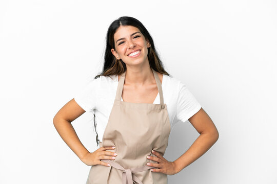 Restaurant waiter over isolated white background posing with arms at hip and smiling