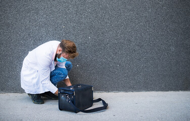 young doctor carrying a doctor's bag