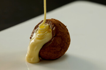 Cooking chocolate truffles, premium creamy chocolate falling from above