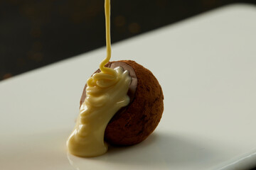 Cooking chocolate truffles, premium creamy chocolate falling from above