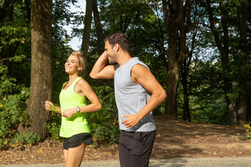Fototapeta premium Handsome couple jogging together in the nature