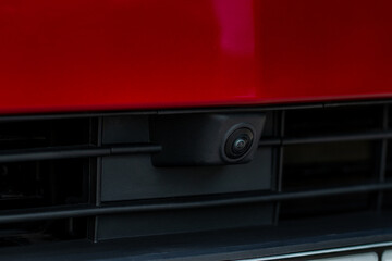 Close up view of front parking assist video camera on the car. Front view camera of modern car.