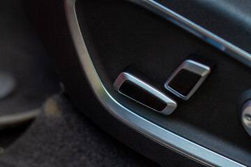 Obraz premium Electric car seat adjustment control panel close up view. Adjustable car seat position. Car interior.
