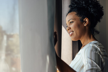 African-american woman, checking if it rains