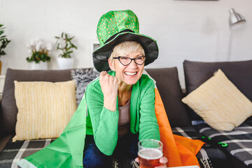 Old Irish lady watching the game on a computer, drinking beer, cheering for Ireland with an Irish...