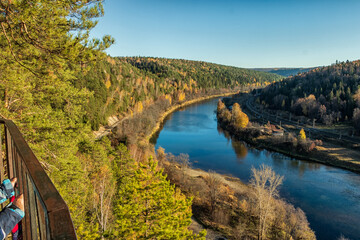 Fototapeta na wymiar A picturesque top view of the Sylva River and the autumn trees growing nearby.