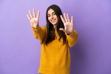 Young caucasian woman isolated on purple background counting nine with fingers