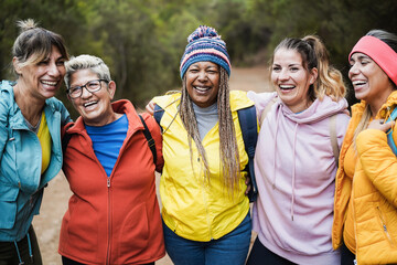 Multiracial women having fun during trekking day in to the wood - Escape to nature and travel...