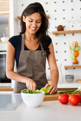 Sporty young woman is preparing healthy food in kitchen