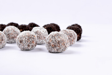 Sweet coconut and Swedish chocolate ball on white background. Selective focus.