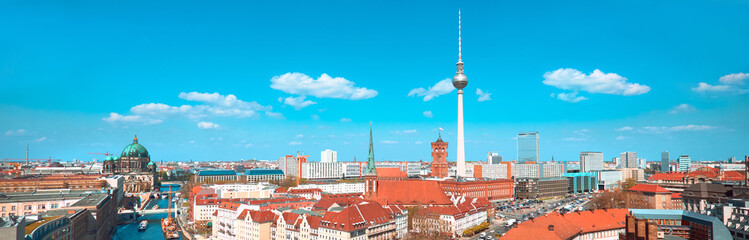 Panoramic aerial view of central Berlin on a bright day in Autumn with blue sky, including river...