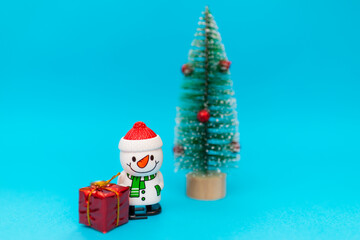 Toy snowman, presents and Christmas tree with copy space.new year celebration.