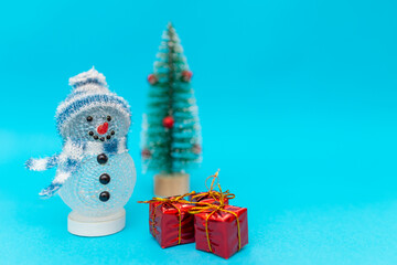 Toy snowman, presents and Christmas tree with copy space.new year celebration.