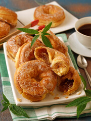 Puff pastry donuts stuffed with pumpkin jam.