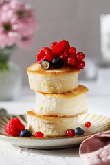 Japanese fluffy pancakes with raspberries. Trendy asian food, Fluffy Japan souffle pancakes,...