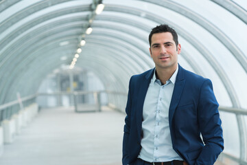 portrait of pleasant businessman is standing in a building