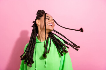 Naklejka na ściany i meble Photo of nice happy pretty dark skin lady fly dreadlocks hair smile isolated on pastel pink color background
