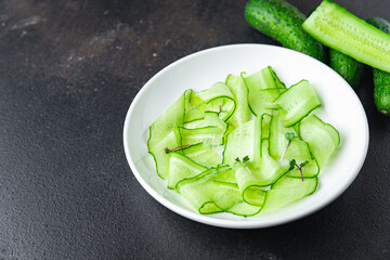 cucumber salad slices vegetable ready to eat meal snack on the table copy space food background rustic. top view keto or paleo diet veggie vegan or vegetarian food