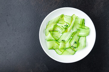 cucumber salad slices vegetable ready to eat meal snack on the table copy space food background rustic. top view keto or paleo diet veggie vegan or vegetarian food