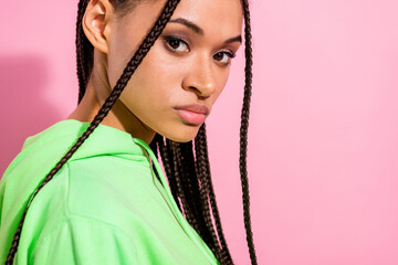 Cropped photo of serious young dark skin woman serious face braids hair isolated on pink color...