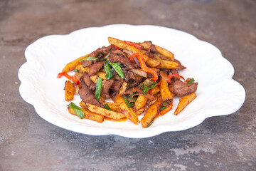 fried meat with french fries and vegetables
