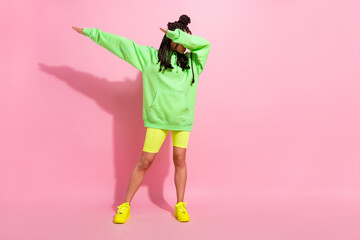Full body photo of happy dark skin young woman dance dab pose isolated on pastel pink color...
