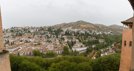 Fototapeta na wymiar View at the main Granada city, view from the Alhambra citadel palace lookout, architecture buildings and horizon, Spain