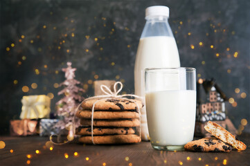 Milk for Santa Claus and Christmas cookies on dark background close-up and copy space concept...