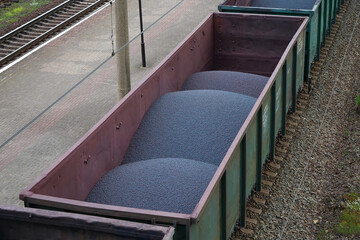 Freight train car with iron ore pellets