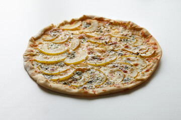 Pizza with cheese and pear fruit on table