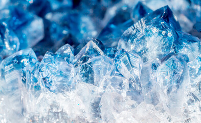 Blue Crystal Mineral Stone. Gems. Mineral crystals in the natural environment. Texture of precious and semiprecious stones. Seamless background with copy space colored shiny surface of precious stones