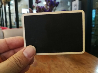 Black sheet in a hand.  Copy space.