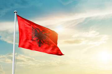 Albania national flag cloth fabric waving on the sky - Image